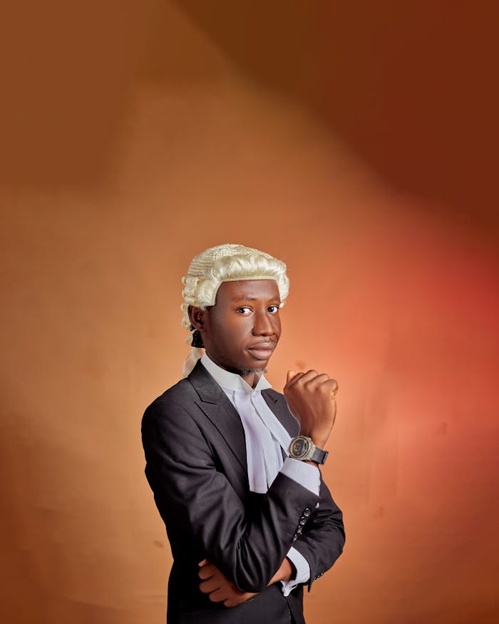 Portrait of a young lawyer wearing a traditional white wig, exuding confidence. Warm tones.